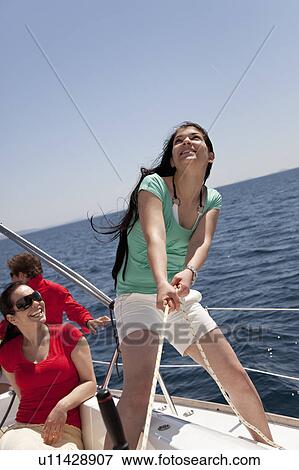 Stock Photo - Team steering yacht. Fotosearch