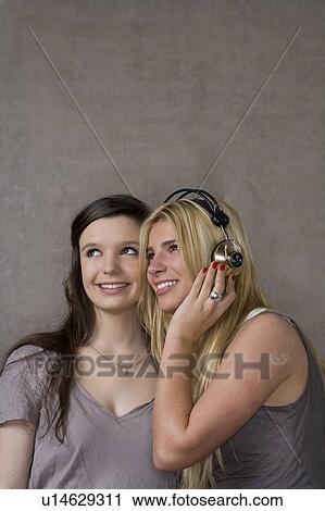 Teen friends with headphones View Large Photo Image Stock Image - Teen friends with headphones. Fotosearch