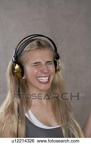 Teen girl smiles wears headphones View Large Photo Image Stock Photograph - Teen girl smiles wears headphones. Fotosearch