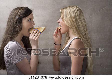 Teen girls eat sandwiches View Large Photo Image Stock Photo - Teen girls eat sandwiches. Fotosearch
