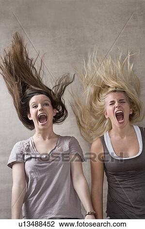 Stock Image - Teen girls laughing together. Fotosearch