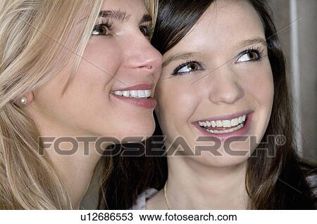 Stock Image - Teen girls smile together. Fotosearch