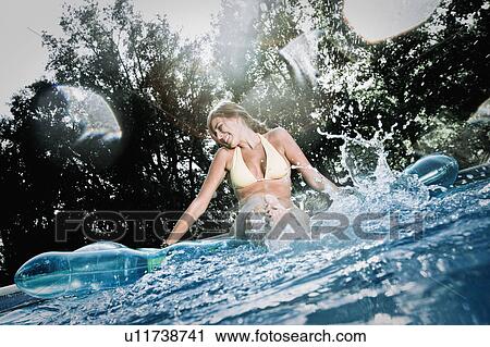 Stock Image - Teen in a pool. Fotosearch