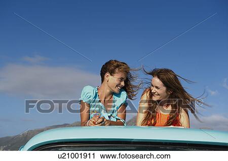 Stock Image - Teenage girls on back of pickup truck. Fotosearch