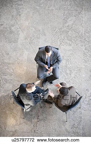 Three businessmen in meeting View Large Photo Image Stock Image - Three businessmen in meeting. Fotosearch