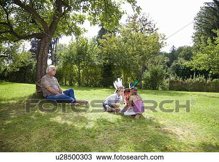Tied up grandfather with grandchildren View Large Photo Image Stock Image - Tied up grandfather with grandchildren. Fotosearch