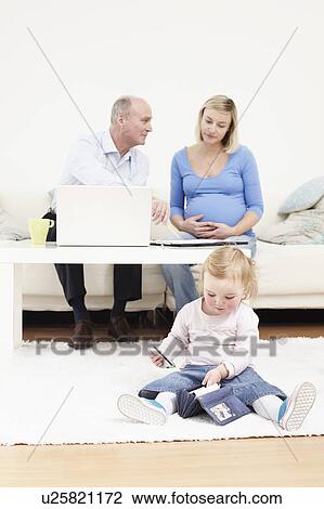 Stock Image - Toddler taking cards out of a purse. Fotosearch