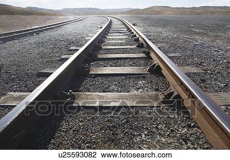 Stock Image - Train tracks stretching into distance. Fotosearch