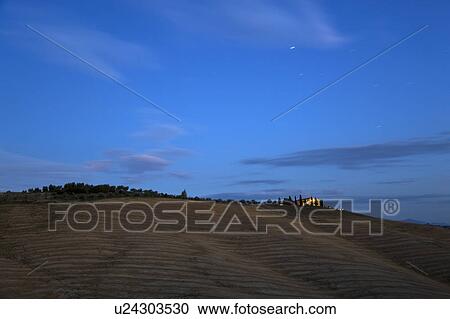 Stock Image - Tuscan country house at dusk. Fotosearch
