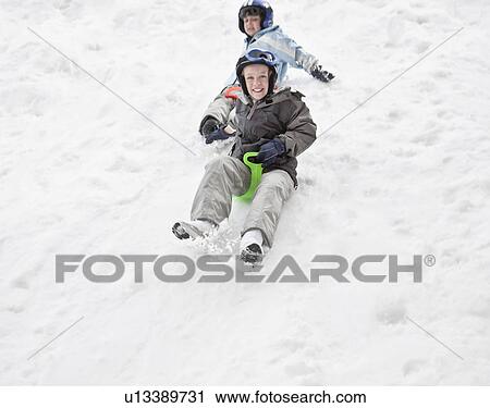 Two boys sledging View Large Photo Image Stock Image - Two boys sledging. Fotosearch