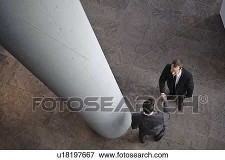 Stock Photo - Two business men are shaking hands. Fotosearch