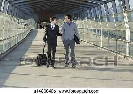 Stock Photography - two businessmen talking. Fotosearch