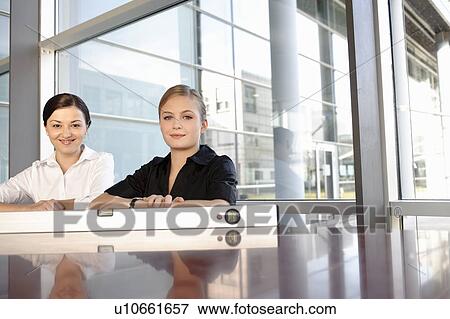 Two businesswomen with spirit level View Large Photo Image Stock Photo - Two businesswomen with spirit level. Fotosearch