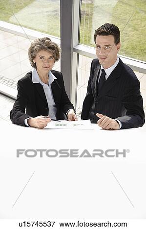 Two colleagues in discussion at work View Large Photo Image Stock Photo - Two colleagues in discussion at work. Fotosearch