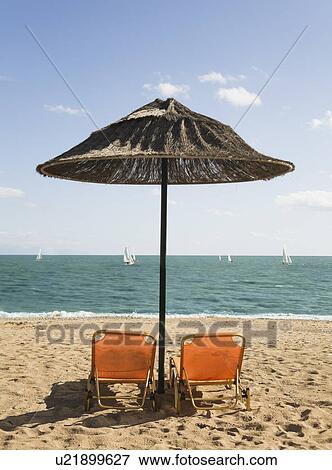 Stock Photo - Two Deck Chairs on a beach. Fotosearch