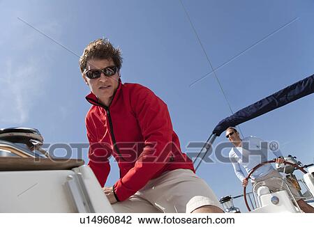 Stock Image - Two men on yacht. Fotosearch