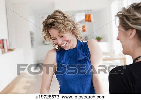 Stock Image - Two woman laughing. Fotosearch