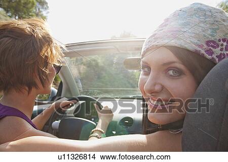 Two women in convertible car in the sun View Large Photo Image Picture - Two women in convertible car in the sun. Fotosearch