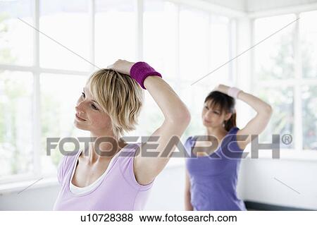 Two women stretching neck View Large Photo Image Stock Photo - Two women stretching neck. Fotosearch