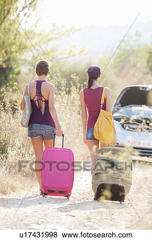Two women walking to their car View Large Photo Image Stock Photo - Two women walking to their car. Fotosearch