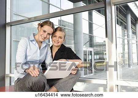 Two young business woman with laptop View Large Photo Image Picture - Two young business woman with laptop. Fotosearch
