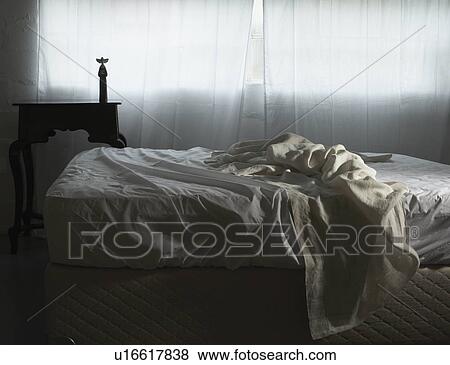 Unmade bed in morning light View Large Photo Image Stock Photo - Unmade bed in morning light. Fotosearch