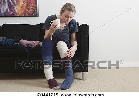 Stock Photo - Woman admiring homemade socks. Fotosearch