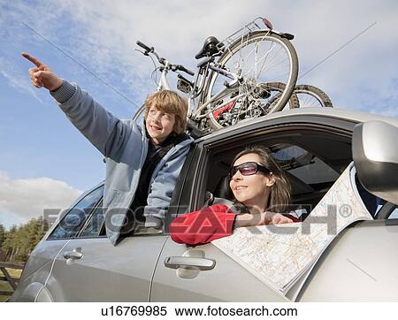 Stock Photography - Woman and boy in car using map. Fotosearch