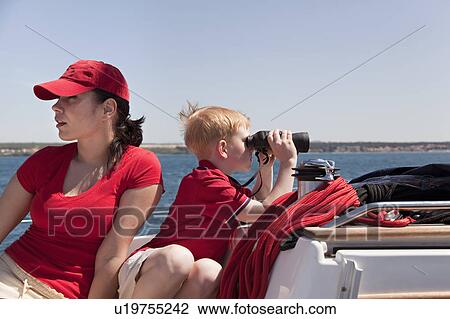 Stock Image - Woman and boy on yacht. Fotosearch