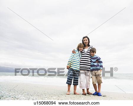 Woman and two boys on a Beach View Large Photo Image Picture - Woman and two boys on a Beach. Fotosearch