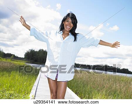 Woman arms spread, smiling View Large Photo Image Stock Image - Woman arms spread, smiling. Fotosearch