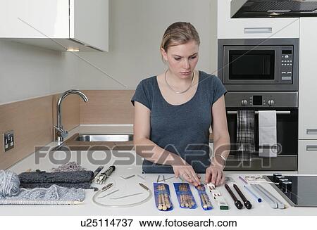 Woman arranging knitting and needles View Large Photo Image Stock Photo - Woman arranging knitting and needles. Fotosearch