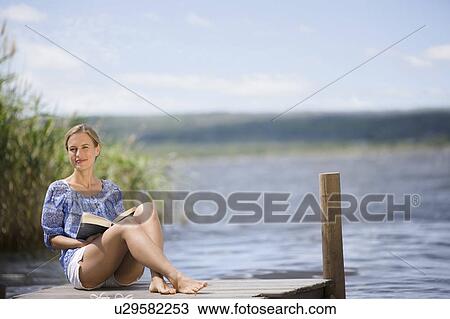 Stock Image - Woman at a lake. Fotosearch