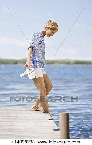 Stock Photo - Woman at a lake. Fotosearch
