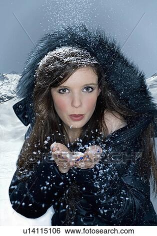 Woman blows snow from hand View Large Photo Image Stock Photograph - Woman blows snow from hand. Fotosearch