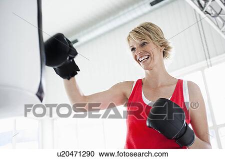 Woman boxing punching bag View Large Photo Image Stock Image - Woman boxing punching bag. Fotosearch