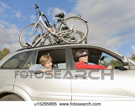 Woman & boy in car, bikes on roof View Large Photo Image Stock Photography - Woman & boy in car, bikes on roof. Fotosearch