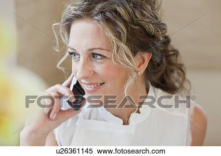 Stock Photography - Woman chatting on a mobile phone. Fotosearch