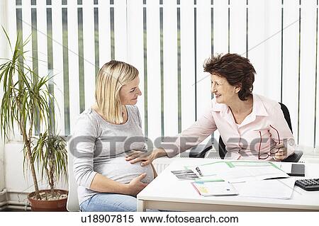 Woman consulting pregnant woman View Large Photo Image Stock Photography - Woman consulting pregnant woman. Fotosearch
