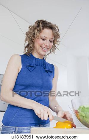Woman cutting yellow bell pepper View Large Photo Image Stock Image - Woman cutting yellow bell pepper. Fotosearch
