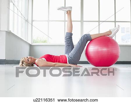 Woman doing leg exercise with gymball View Large Photo Image Stock Image - Woman doing leg exercise with gymball. Fotosearch