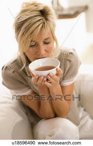Stock Image - Woman drinking tea. Fotosearch