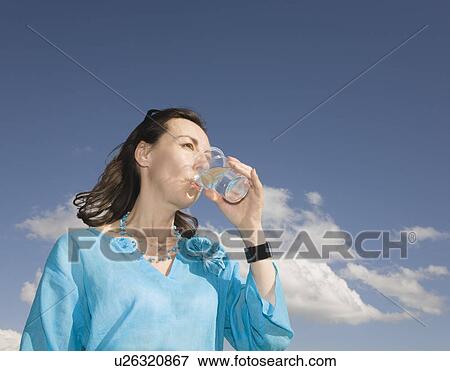 Woman drinking water View Large Photo Image Stock Photo - Woman drinking water. Fotosearch