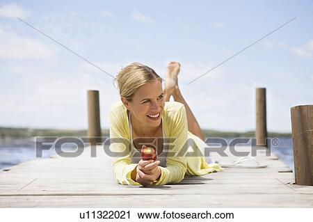 Stock Image - Woman eating a fruit. Fotosearch