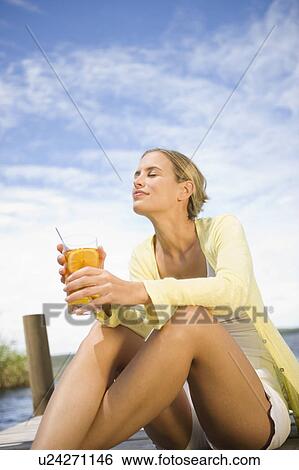 Stock Photograph - Woman enjoying a cold drink. Fotosearch