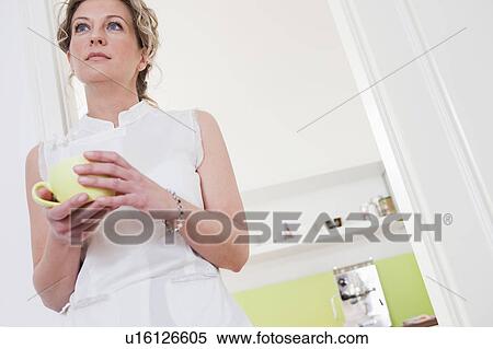 Stock Photography - Woman holding a cup of coffee. Fotosearch