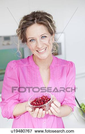Woman holding a cup of pomegranate View Large Photo Image Stock Photo - Woman holding a cup of pomegranate. Fotosearch