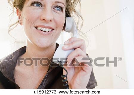 Stock Image - Woman holding a phone. Fotosearch