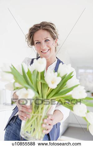 Woman holding a vase with white tulips View Large Photo Image Stock Photo - Woman holding a vase with white tulips. Fotosearch