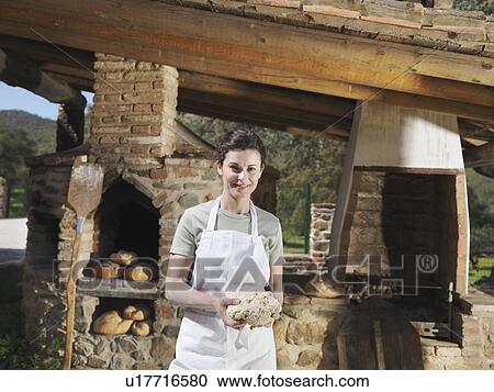 Stock Image - Woman holding bread dough. Fotosearch